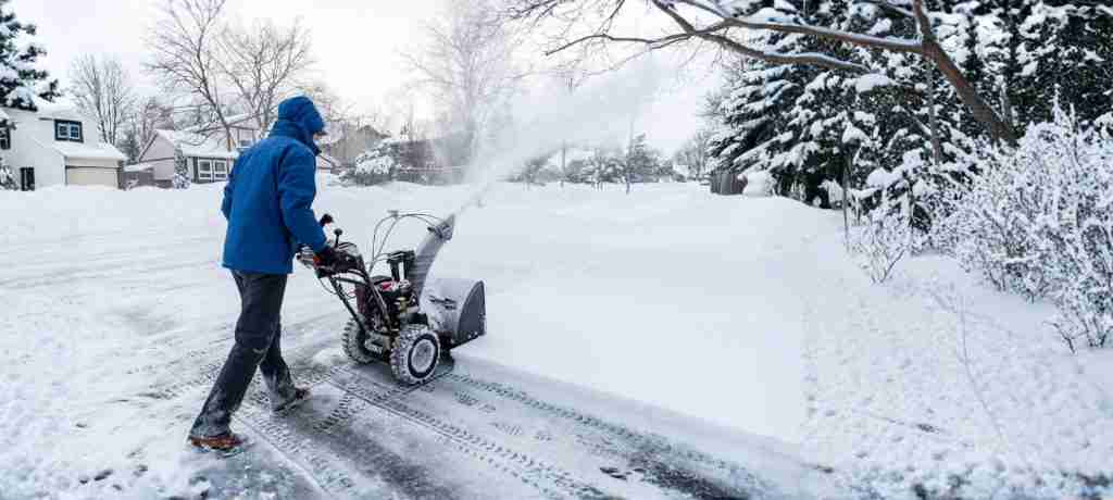 Snow removal team clearing a driveway in Montgomery County, MD